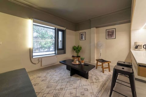 Enjoy a cozy retreat in this stylish living area with modern decor and ample natural light, perfect for relaxation.