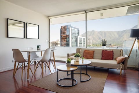 Enjoy stunning mountain views from this stylish living room with modern decor and cozy seating.