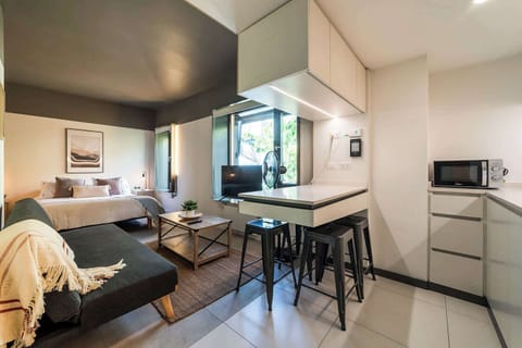 Experience modern comfort in this stylish studio with cozy seating and ample natural light, perfect for a relaxing stay.