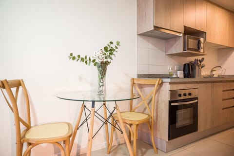 Cozy kitchen with modern amenities and a charming dining nook, perfect for intimate meals.