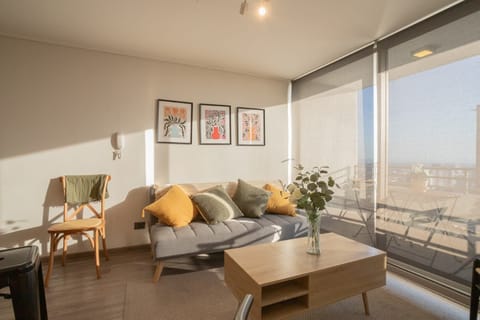 Cozy and sunlit living space with stylish decor and a relaxing ambiance, perfect for unwinding.