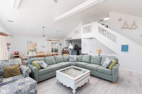 Bright Open-Concept Living Room w/ Vaulted Ceilings, Large Sectional Sofa, Expansive Windows, Natural Light, Smart TV, and Scenic Outdoor Views