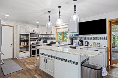 Full kitchen equipped with all essential cooking and eating needs.