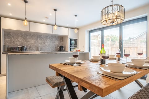 Ground floor: Bi-fold doors open the dining area to the front courtyard