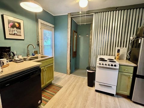 Rustic finishes with modern conveniences. Stone countertops, stainless steel sink, dishwasher. 