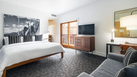 Unwind in a spacious bedroom with balcony and lounge chair.