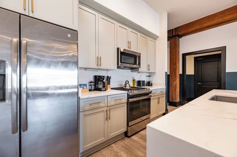 Cook or snack in style with a full kitchen featuring GE stainless appliances, cookware, and an island with bar seating. Ideal for short or extended stays, our kitchens make group travel in New Orleans easy and comfortable.