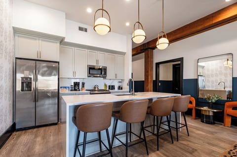 Cook or snack in style with a full kitchen featuring GE stainless appliances, cookware, and an island with bar seating. Ideal for short or extended stays, our kitchens make group travel in New Orleans easy and comfortable.
