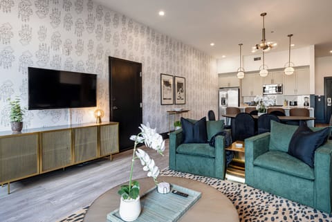 Relax in the living area with a smart TV, stylish seating, and a sleeper sofa for extra guests. Perfect for families or group stays in New Orleans, this inviting space is ideal for movie nights or recharging after a day in the city.