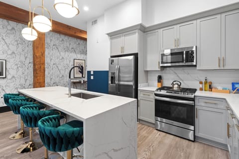 Cook or snack in style with a full kitchen featuring GE stainless appliances, cookware, and an island with bar seating. Ideal for short or extended stays, our kitchens make group travel in New Orleans easy and comfortable.