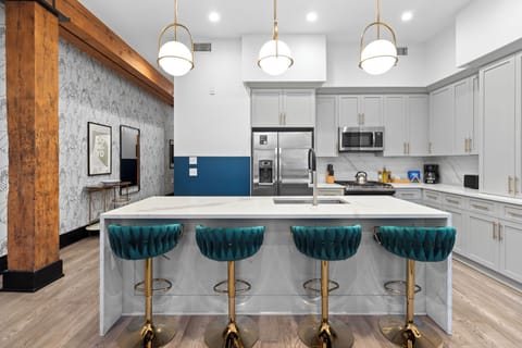 Cook or snack in style with a full kitchen featuring GE stainless appliances, cookware, and an island with bar seating. Ideal for short or extended stays, our kitchens make group travel in New Orleans easy and comfortable.