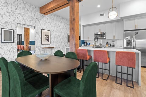 Enjoy meals together at your in-suite dining table with seating for your group. Whether it's takeout, delivery, or a home-cooked meal, this cozy dining area makes every stay at 888 Baronne feel like home in New Orleans.