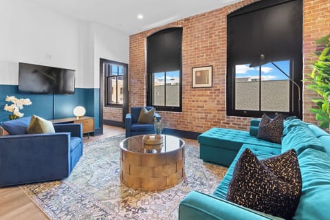 Relax in the living area with a smart TV, stylish seating, and a sleeper sofa for extra guests. Perfect for families or group stays in New Orleans, this inviting space is ideal for movie nights or recharging after a day in the city.