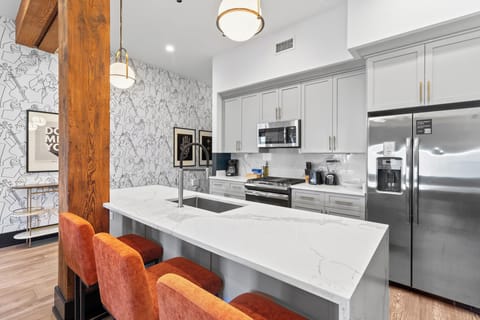 Cook or snack in style with a full kitchen featuring GE stainless appliances, cookware, and an island with bar seating. Ideal for short or extended stays, our kitchens make group travel in New Orleans easy and comfortable.