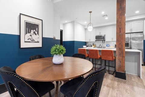 Enjoy meals together at your in-suite dining table with seating for your group. Whether it's takeout, delivery, or a home-cooked meal, this cozy dining area makes every stay at 888 Baronne feel like home in New Orleans.