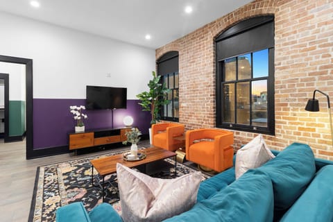 Relax in the living area with a smart TV, stylish seating, and a sleeper sofa for extra guests. Perfect for families or group stays in New Orleans, this inviting space is ideal for movie nights or recharging after a day in the city.