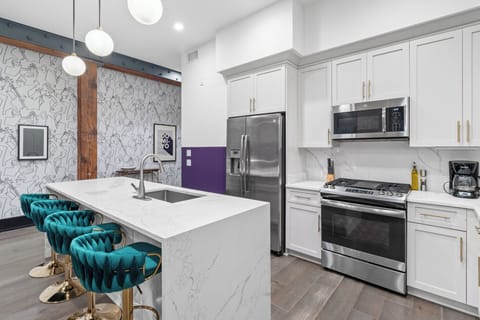 Cook or snack in style with a full kitchen featuring GE stainless appliances, cookware, and an island with bar seating. Ideal for short or extended stays, our kitchens make group travel in New Orleans easy and comfortable.