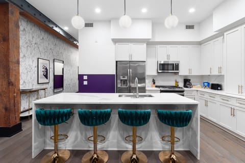 Cook or snack in style with a full kitchen featuring GE stainless appliances, cookware, and an island with bar seating. Ideal for short or extended stays, our kitchens make group travel in New Orleans easy and comfortable.