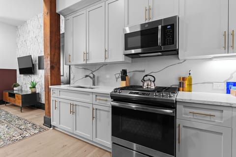 Cook or snack in style with a full kitchen featuring GE stainless appliances, cookware, and an island with bar seating. Ideal for short or extended stays, our kitchens make group travel in New Orleans easy and comfortable.