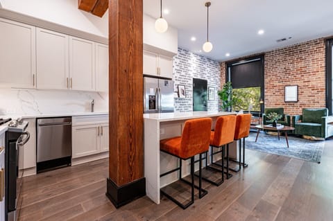 Cook or snack in style with a full kitchen featuring GE stainless appliances, cookware, and an island with bar seating. Ideal for short or extended stays, our kitchens make group travel in New Orleans easy and comfortable.