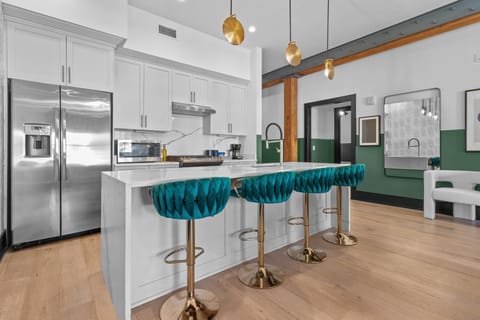 Cook or snack in style with a full kitchen featuring GE stainless appliances, cookware, and an island with bar seating. Ideal for short or extended stays, our kitchens make group travel in New Orleans easy and comfortable.