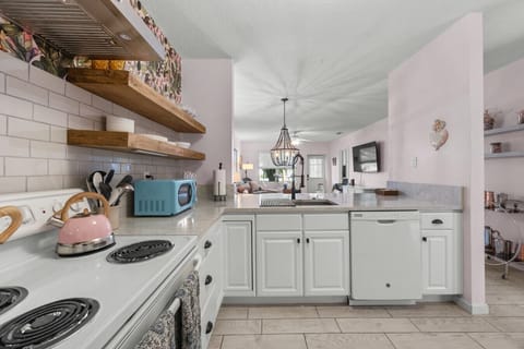 view from kitchen into cozy dining/living area