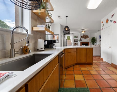 Cozy kitchen with wooden cabinetry and terracotta tiles.