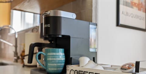 Cozy home coffee station with Keurig and coffee essentials.