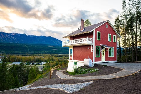 Embrace the charm of a Swiss-style chalet framed by towering pines and breathtaking mountain landscapes.
