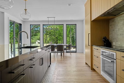 Inviting kitchen with a stunning island and charming wooden floors - the heart of the home.