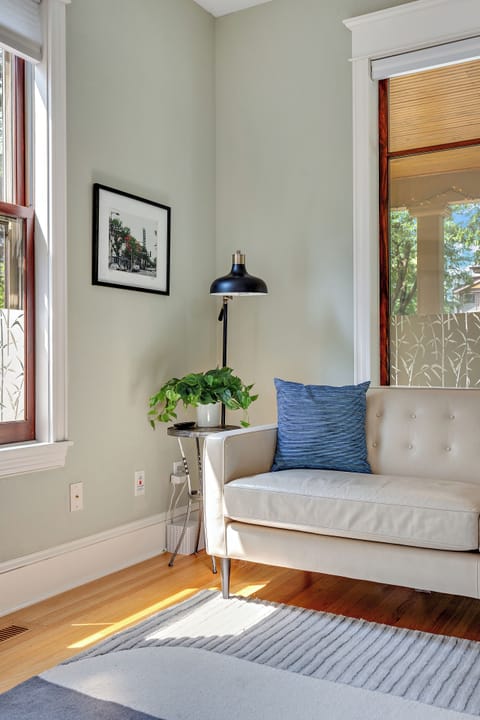 Living Room is filled with light from 7-foot windows and 79" Room & Board couch.