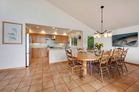 The large dining table invites happy gatherings, laughter over games, and feasting with friends.