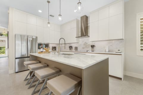 Marble kitchen island in the gorgeous chef's kitchen w/ custom Italian cabinets