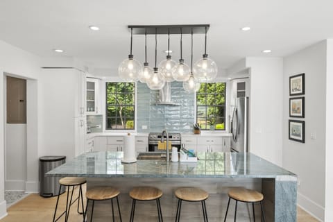 Gather around the stylish kitchen bar perfect for morning coffee, casual bites, or sharing drinks while the chef cooks.