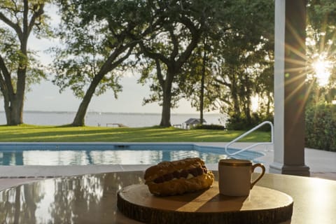 Breakfast and coffee with a view-start your morning under the oaks with the peaceful river just steps away.