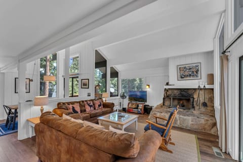 Living Room: 2 sofas, Smart TV, custom stone wood fireplace, board games, access to deck