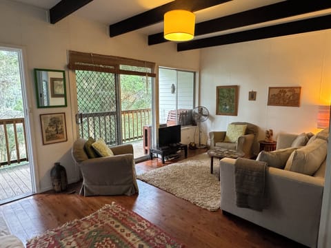 Lounge room looking to back deck and lake through trees