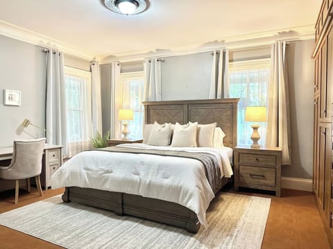 Bright bedroom with large windows and elegant furnishings for a peaceful retreat