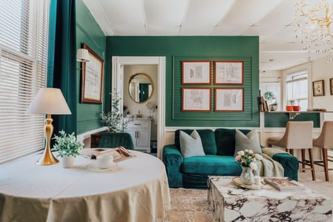 Elegant living space with rich green tones and timeless charm