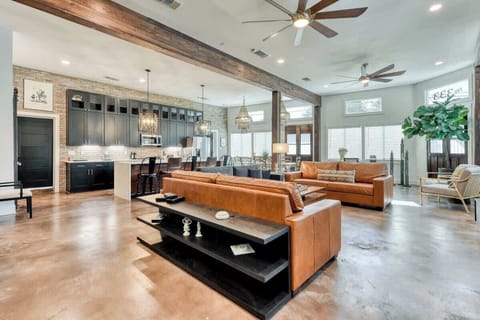 Sadie Street Living room is open to Kitchen and Dining with large windows and abundant natural light