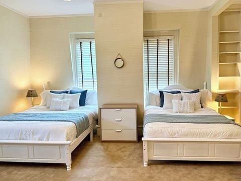 Spacious twin beds adorned with comfy pillows