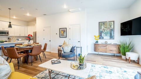 Enjoy a bright and comfortable living room with modern furnishings and cozy seating, the perfect place to unwind after exploring Arlington's entertainment district.