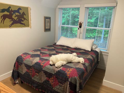 Firm queen bed with cotton sheets.