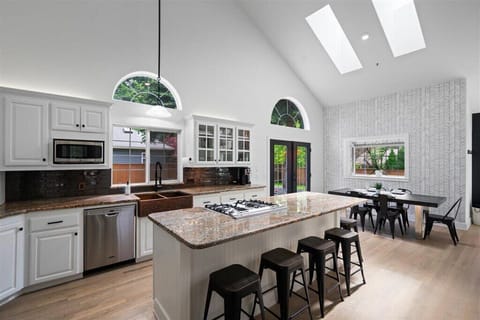 Large kitchen island with 6 bar stools, dishwasher, micro, air fryer, toaster.