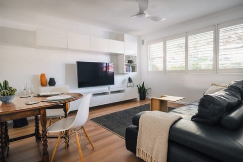 Good size living area with King Leather lounge, 55" Smart TV and books.