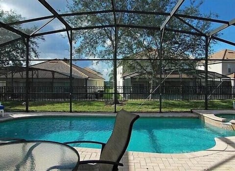 Relax by the screened private pool with scenic views for ultimate comfort and privacy.