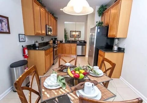Fully equipped kitchen with a cozy dining area, perfect for homemade meals and family time.