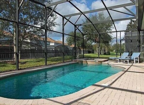 Relax by the screened private pool with scenic views for ultimate comfort and privacy.