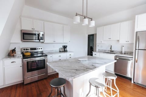 Kitchen with marble counter and deck access