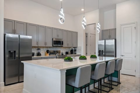 Prepare gourmet meals in the fully equipped modern kitchen, complete with two refrigerators, an oven, microwave, dishwasher, and ample counter space.